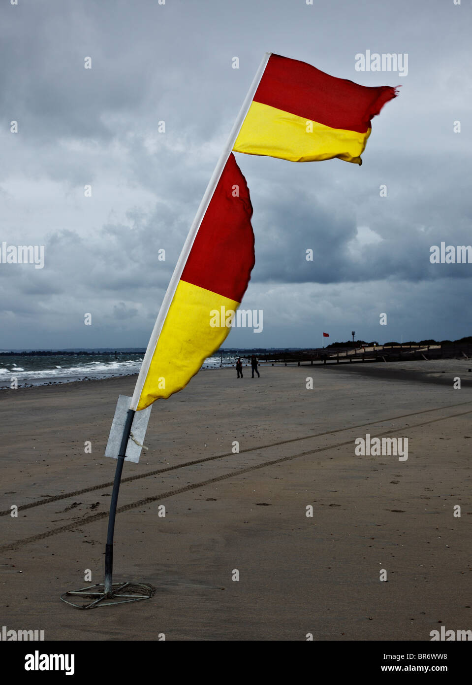 Windy beach & safety flags. Stock Photo