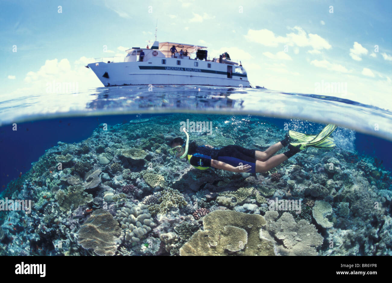 Split level of snorkeller and boat at the Great Barrier Reef, Coral Sea, Australia Stock Photo