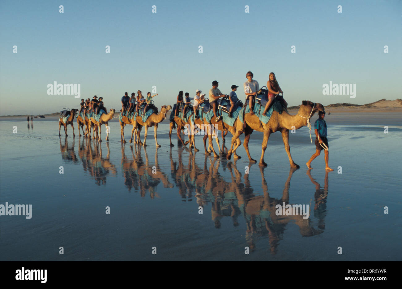 Tourists on a Camel ride along Cable Beach at sunset, Broome, Western ...