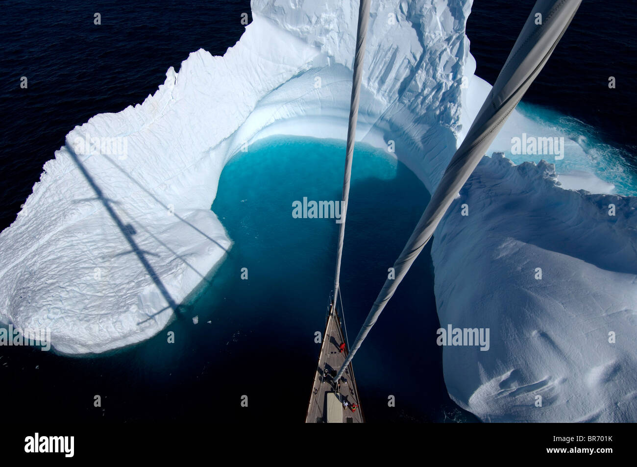 Aerial view, taken from the mast, of SY 'Adele''s bow in the bay of an iceberg, Portal Point, Reclus Pennisula, Antarctica, Janu Stock Photo