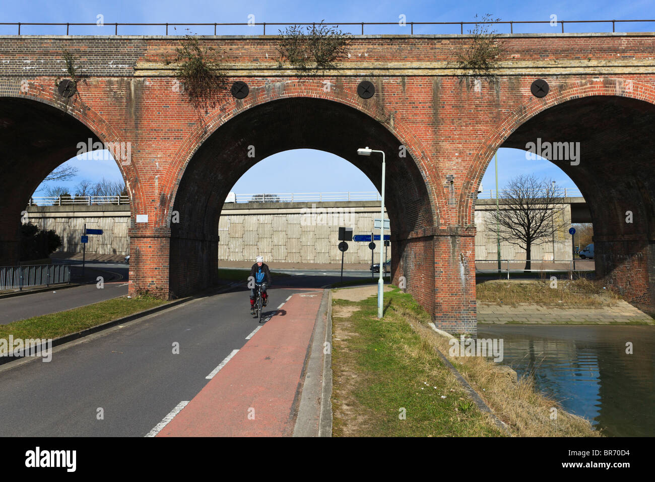 Cyclist on a Cycle path under the Arches of the Brick Railway Viaduct at Fareham, Hampshire, UK Stock Photo