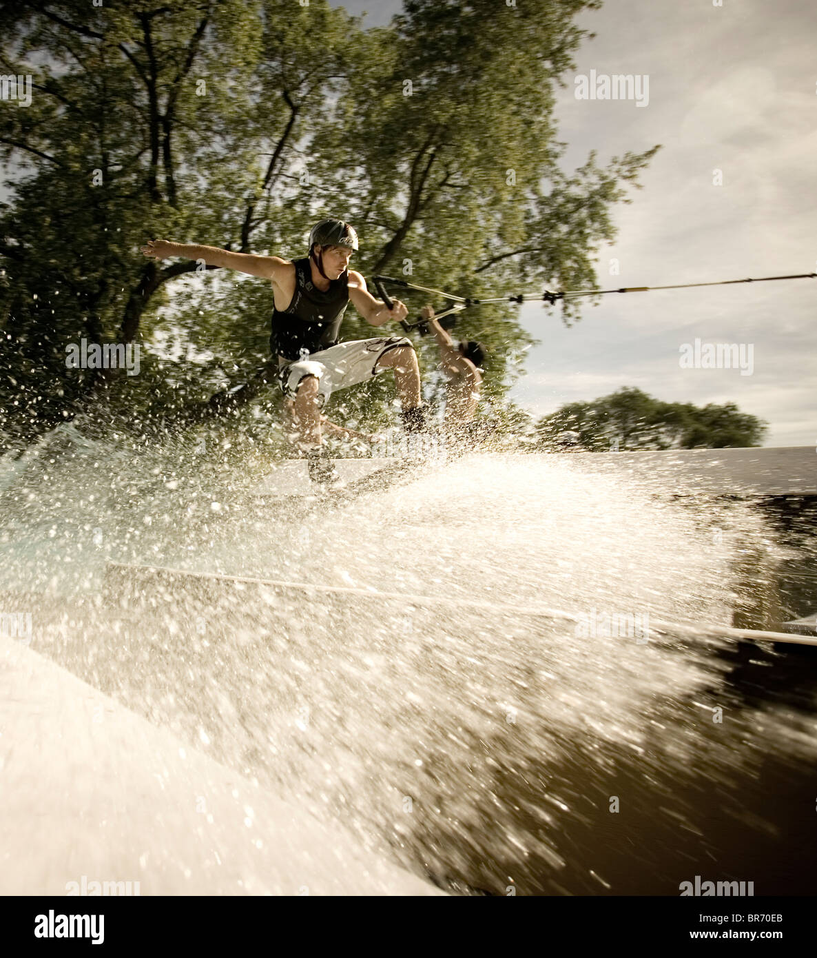 Wakeboard stunt rider performs a railslide in Toronto Ontario Stock