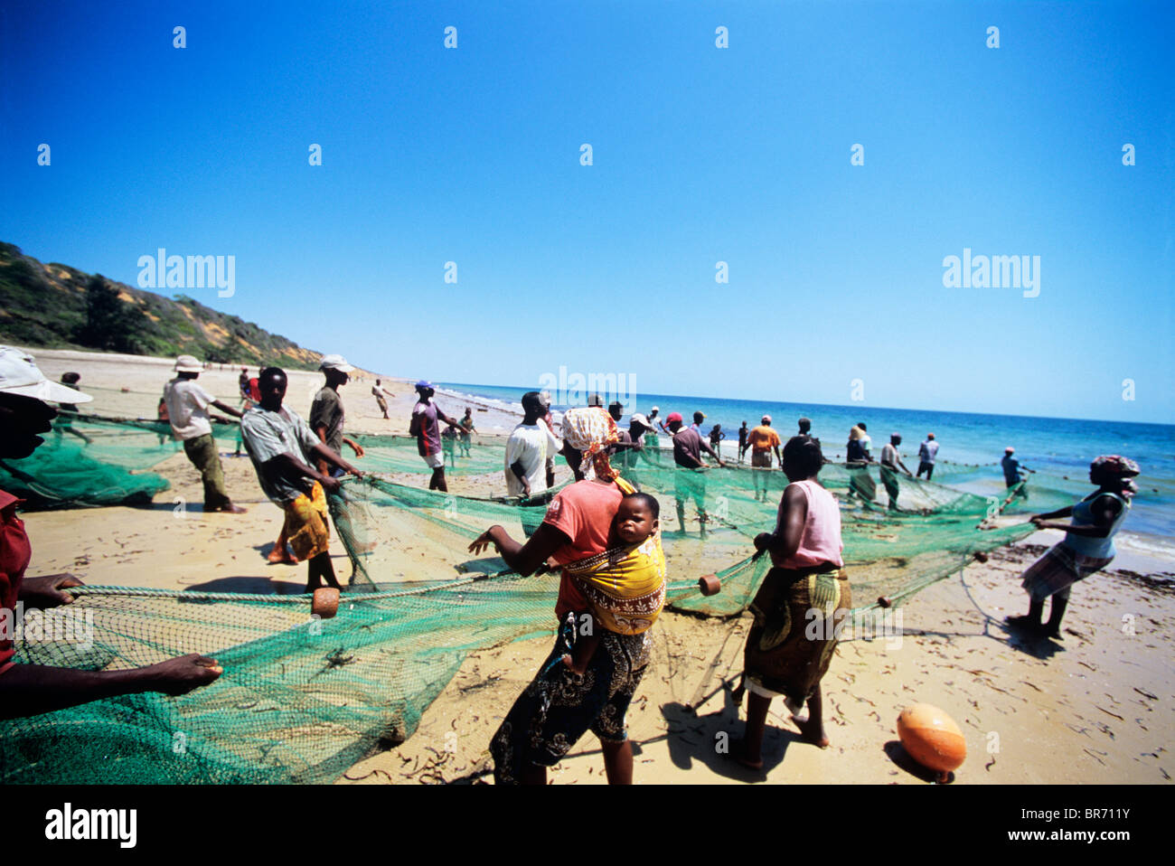 Fishermen pulling in beach seine net in the early morning
