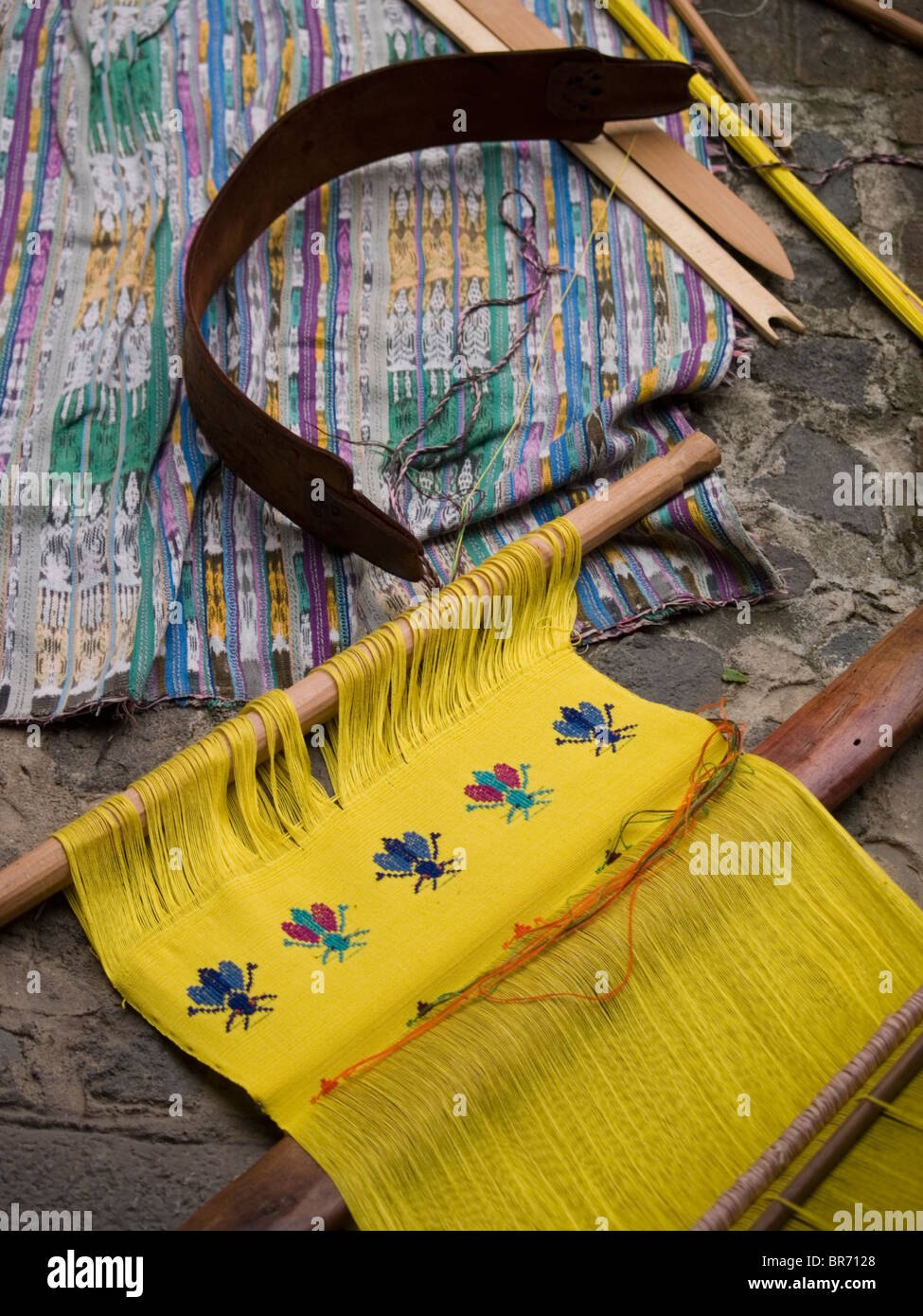 A woman from an indigenous community in Guatemala weaving while wearing