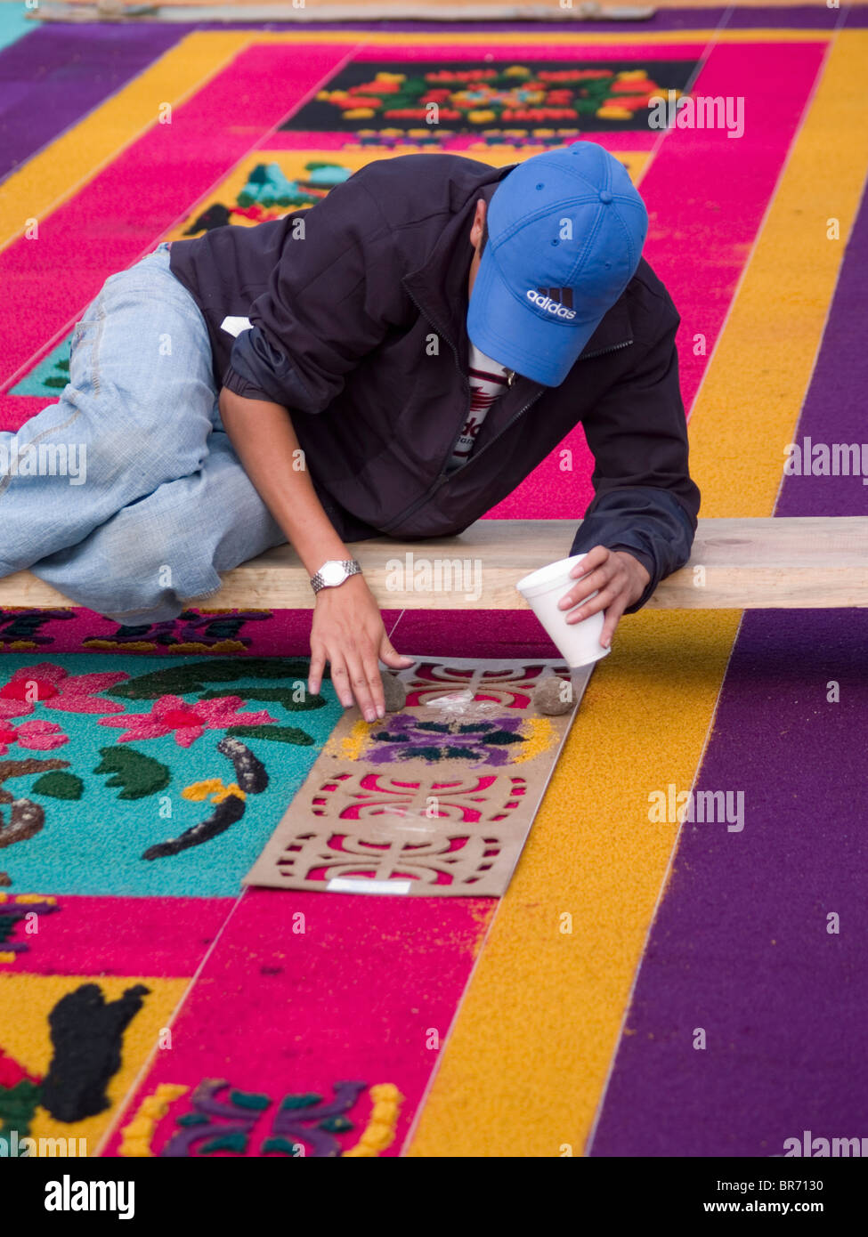 As part of the observance of Lent in Guatemala a person prepares an aromatic carpet for a procession in Antigua Guatemala. Stock Photo