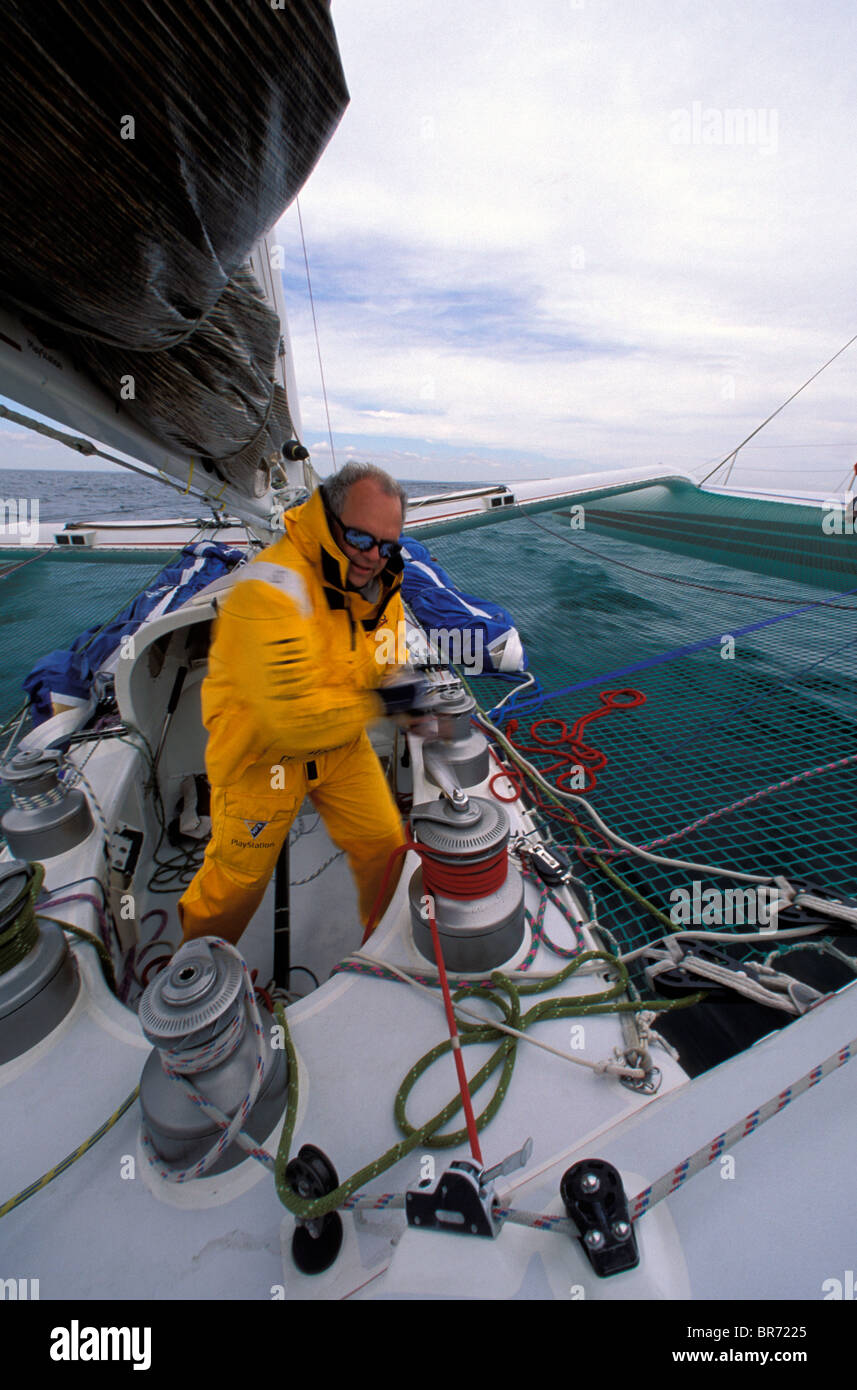 Round the World record holder Steve Fossett winching on trimaran "Playstation". Stock Photo
