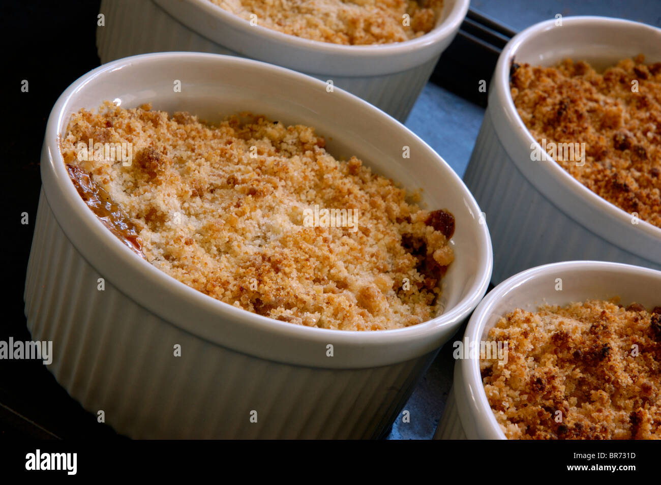Ramekin Dishes With Individual Servings Of Apple Crumble / Crisp Stock