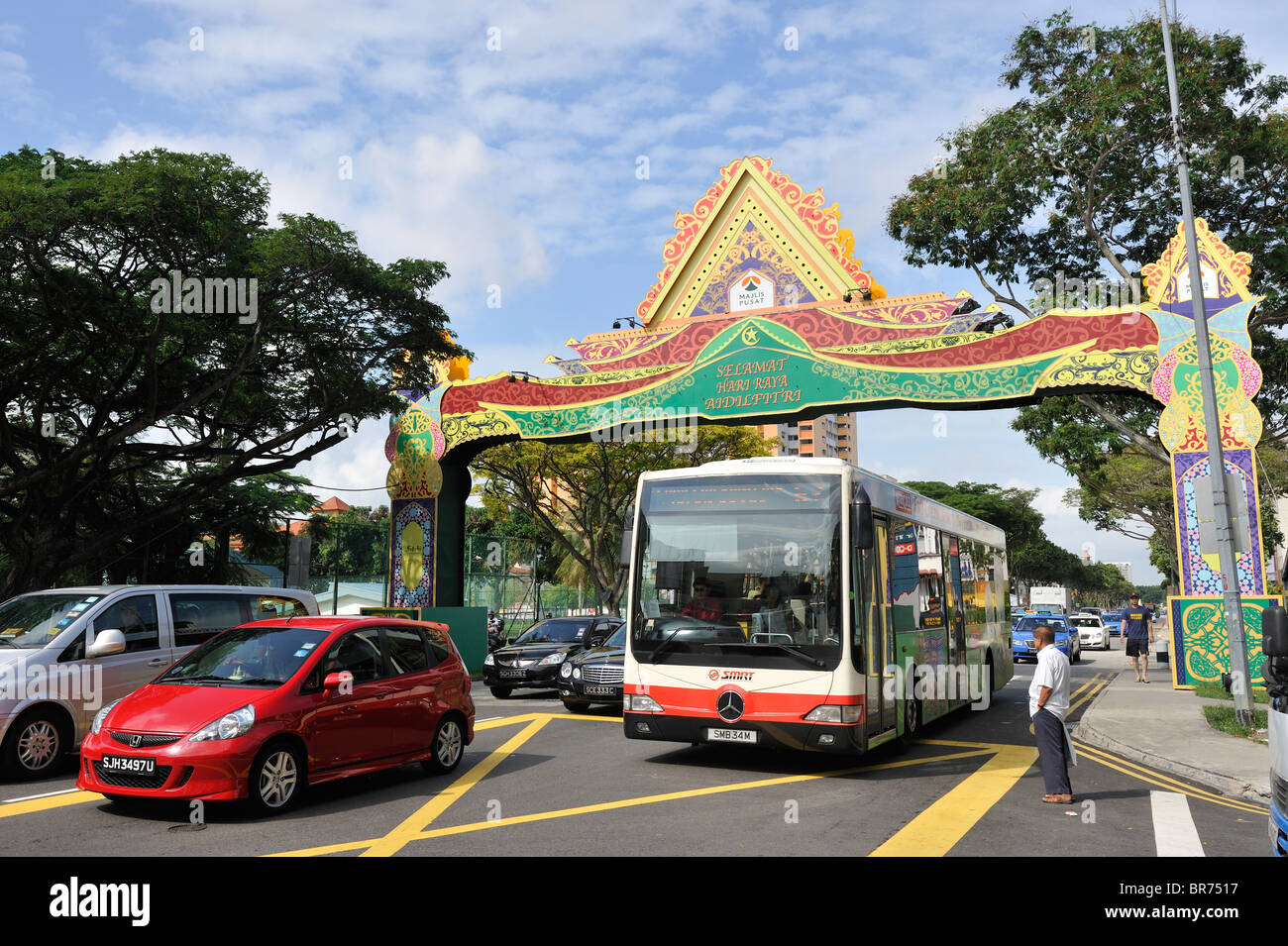 Busy Singapore traffic under an arch in Geylang celebrating ramadan. Stock Photo