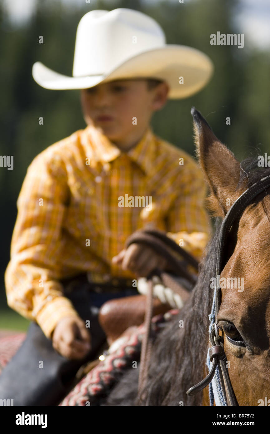 Young cow boy on horse Wyoming Stock Photo