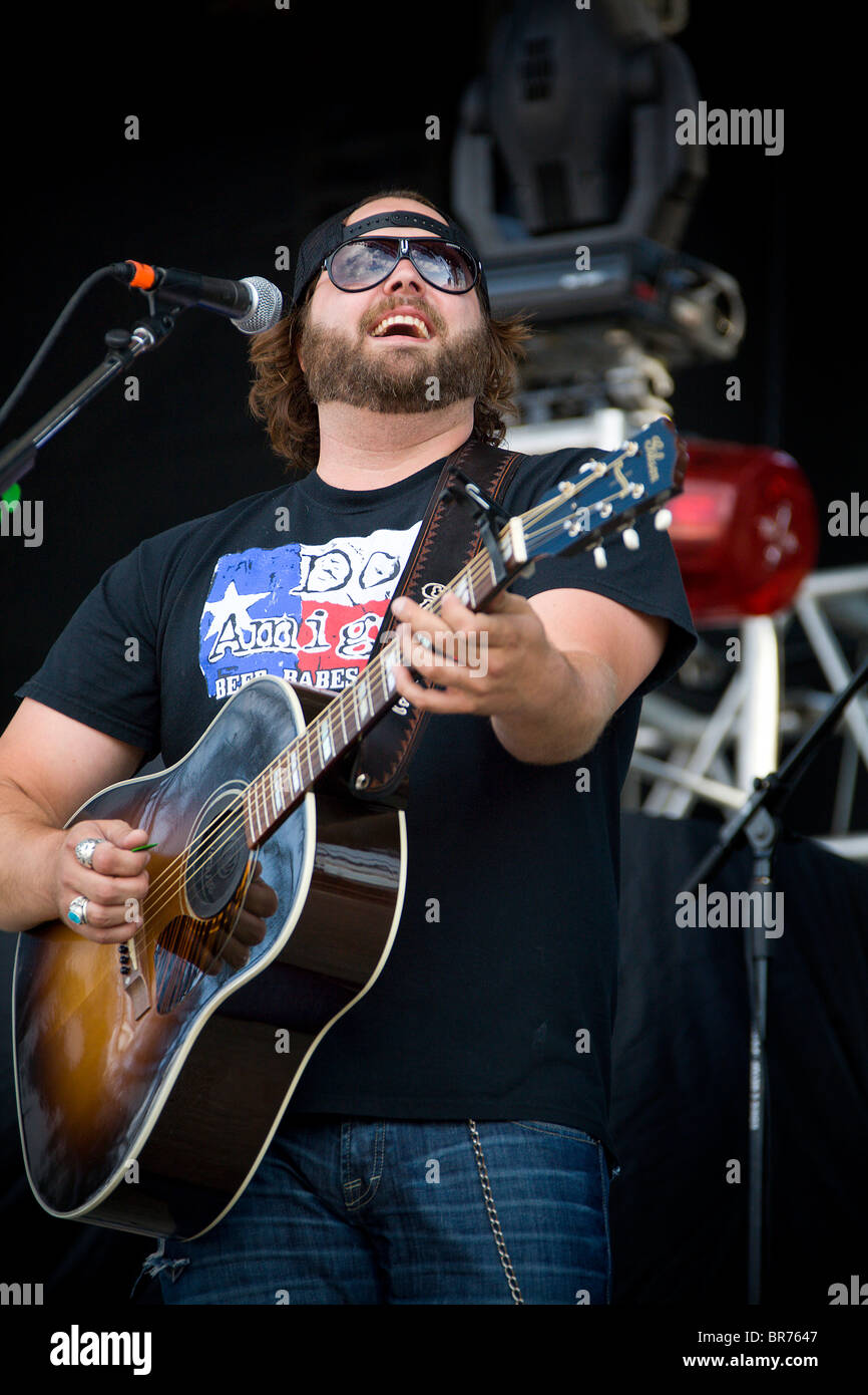 Country Singer Randy Houser Smiling behind the microphone with his guitar on stage at WeFest 2010 in Detroit Lakes Minnesota Stock Photo