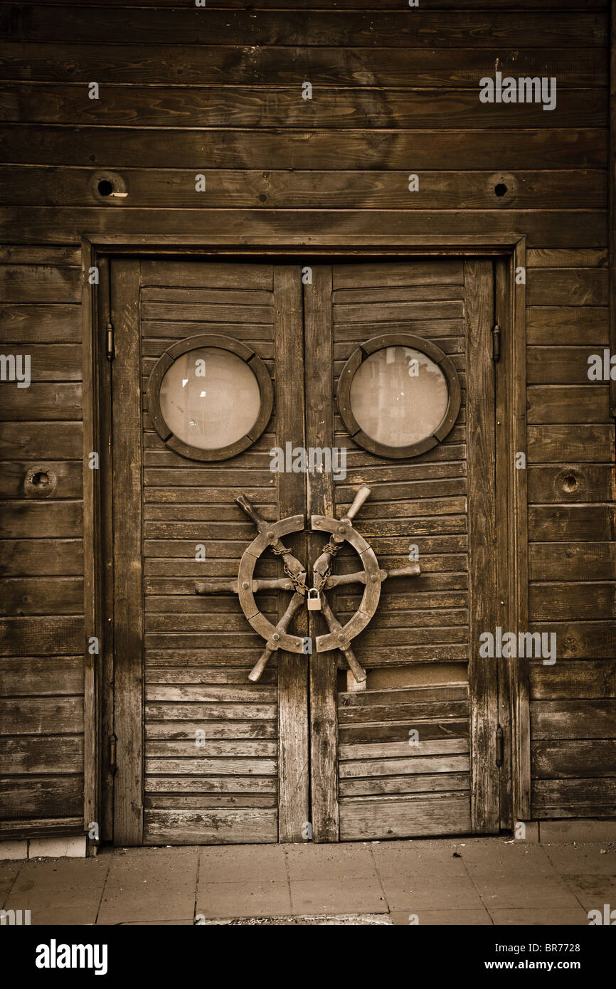 Old wooden door on an abandoned boat, vintage style. Stock Photo