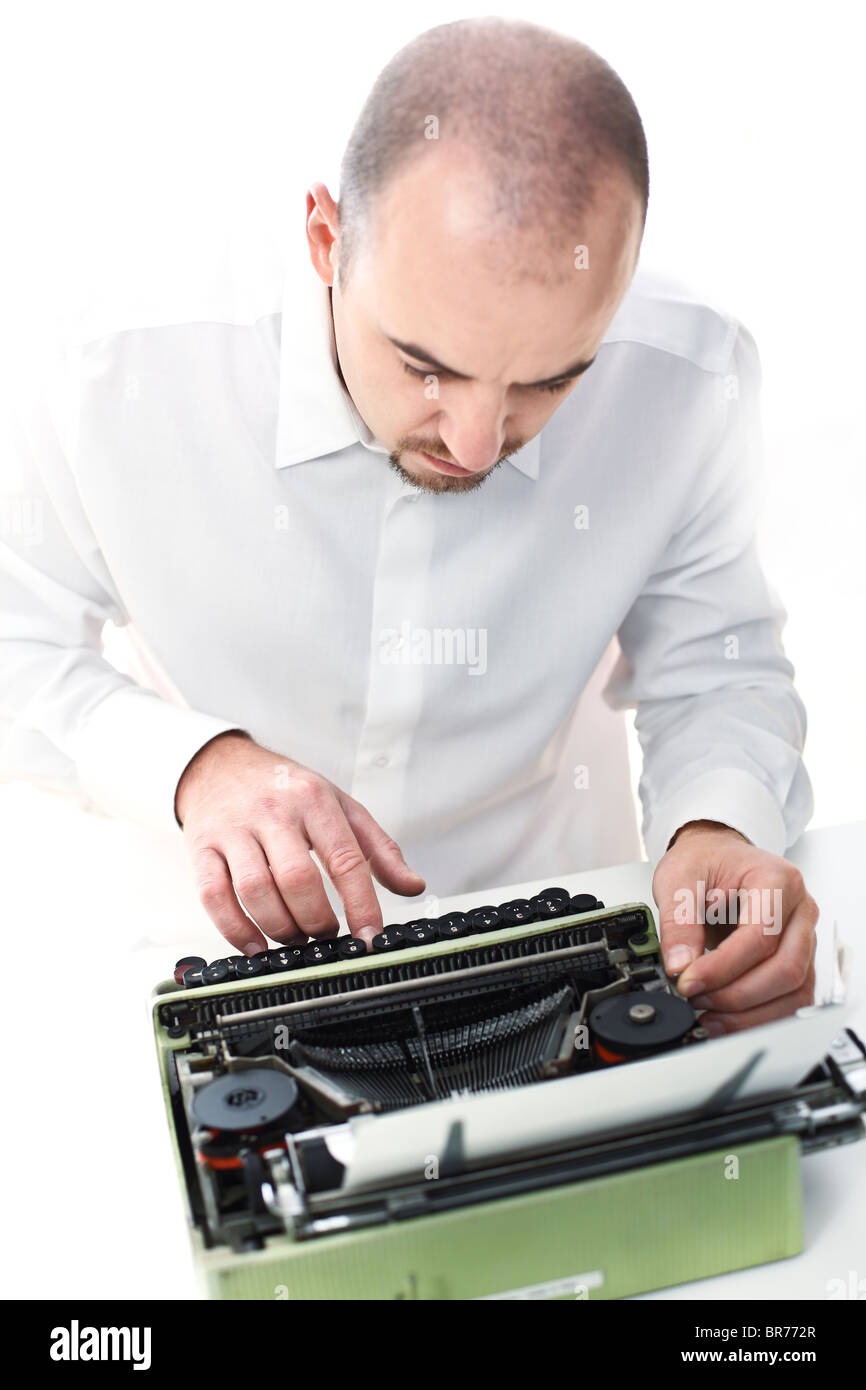 young man with old typewriter selective focus image Stock Photo