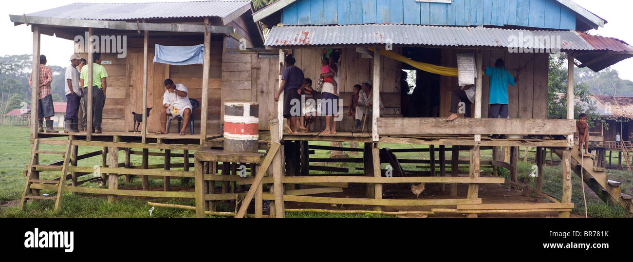 Several people gather outside of homes on stilts in the remote indigenous Miskito village in Krin Krin Nicaragua located on th Stock Photo