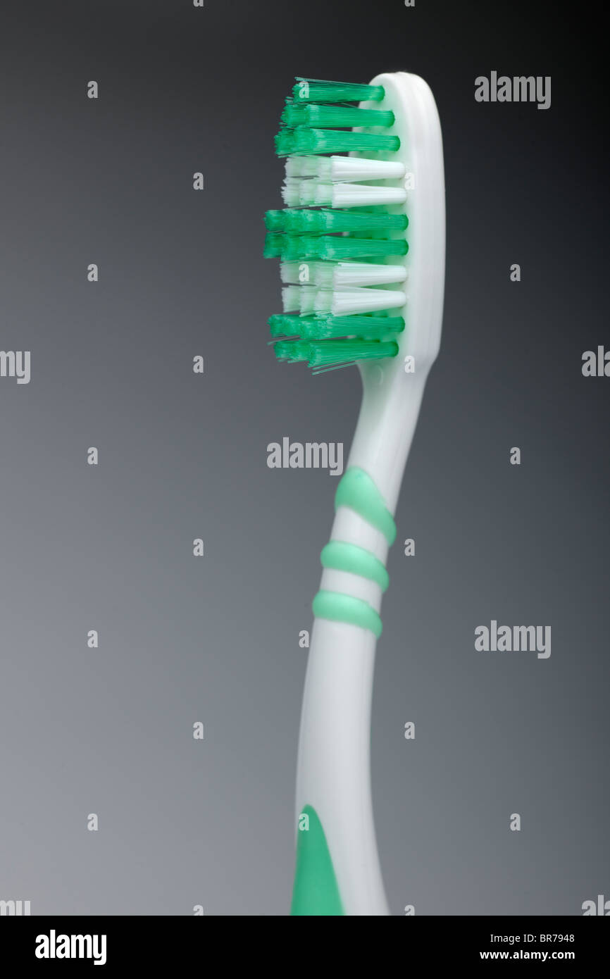 Green and white flexible head toothbrush Stock Photo
