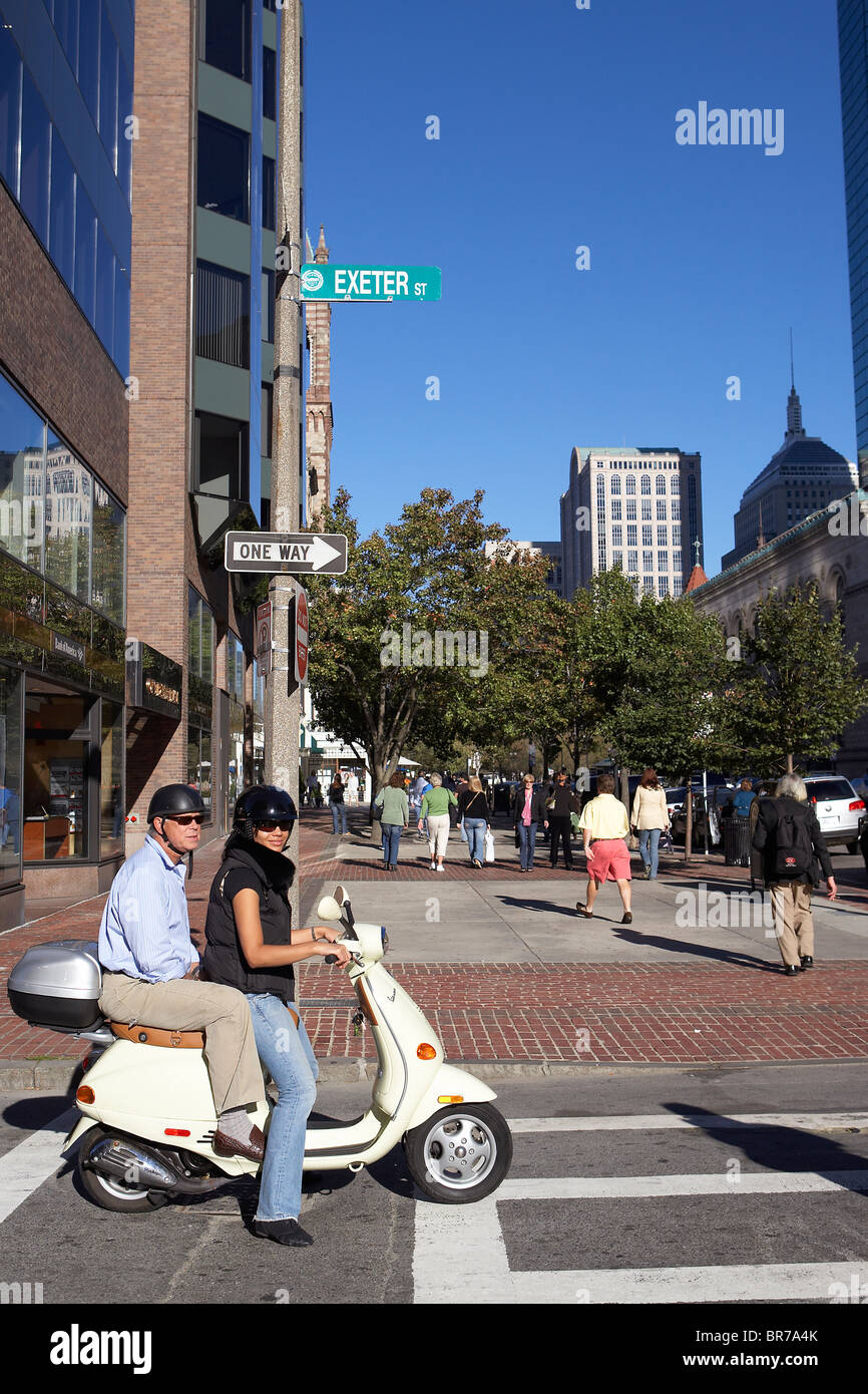A couple rides their moped in Boston Stock Photo Alamy