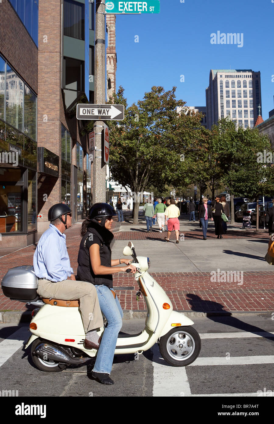 A couple rides their moped in Boston Stock Photo - Alamy
