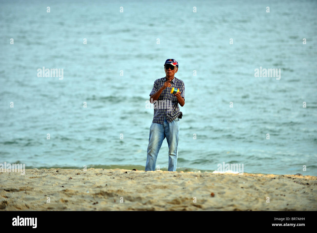 Man flying a kite on the East Coast Beach in Singapore, Asia Stock Photo