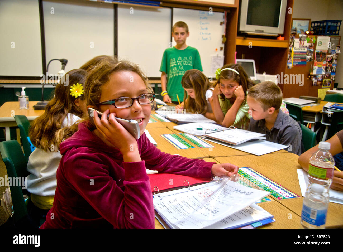 A middle school student uses a cell phone in class in San Clemente, CA. Stock Photo