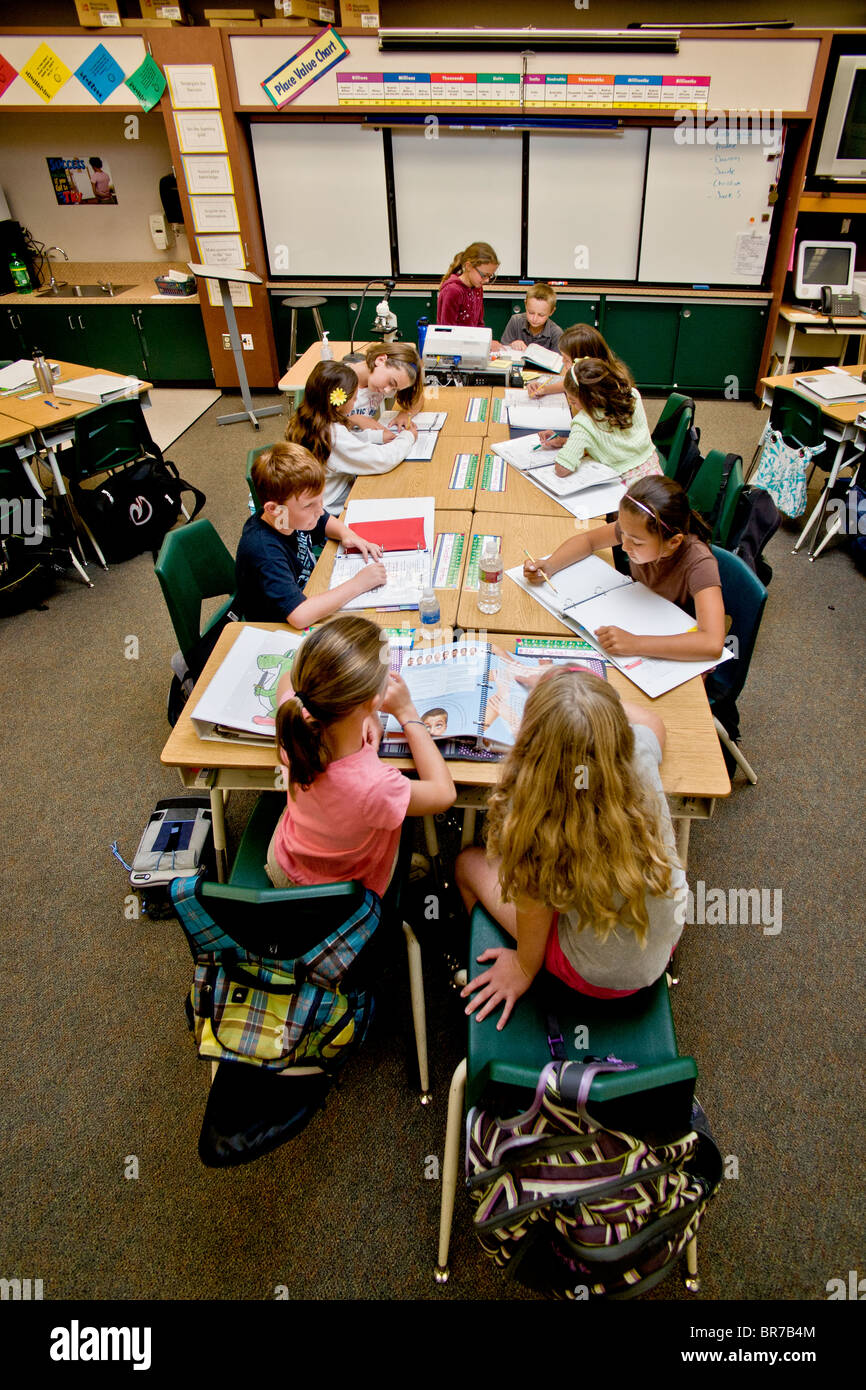Students work at desks in a middle school class in San Clemente, CA