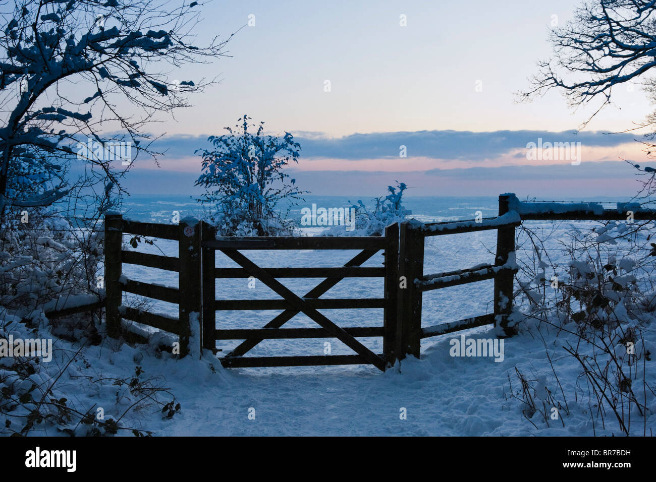 Gate and snow scene in the Surrey Hills, near Reigate England Stock Photo