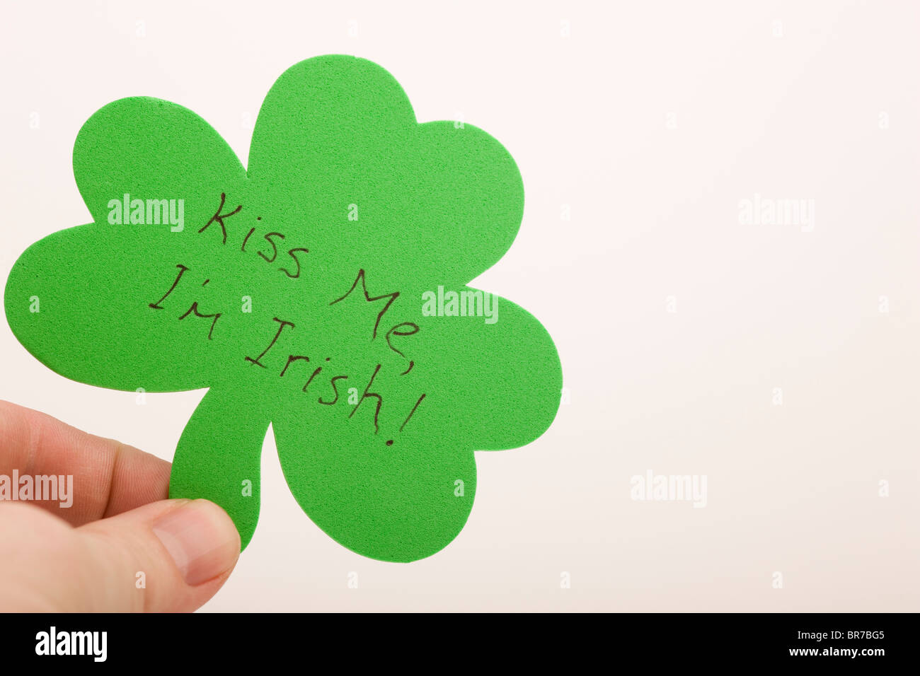 A Hand Holding A Shamrock Saying, 'kiss Me, I'm Irish'; Edmonton, Alberta, Canada Stock Photo
