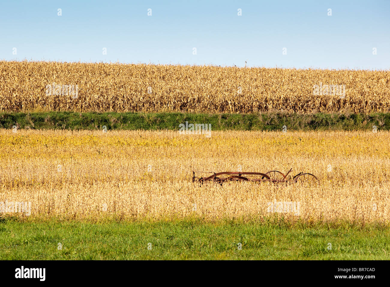 An Iowa farmer’s hay rake nestled in rolling hills and picturesque