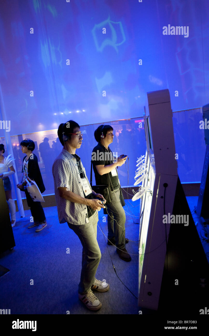 Computer gamers try new games at the trade stalls of various game