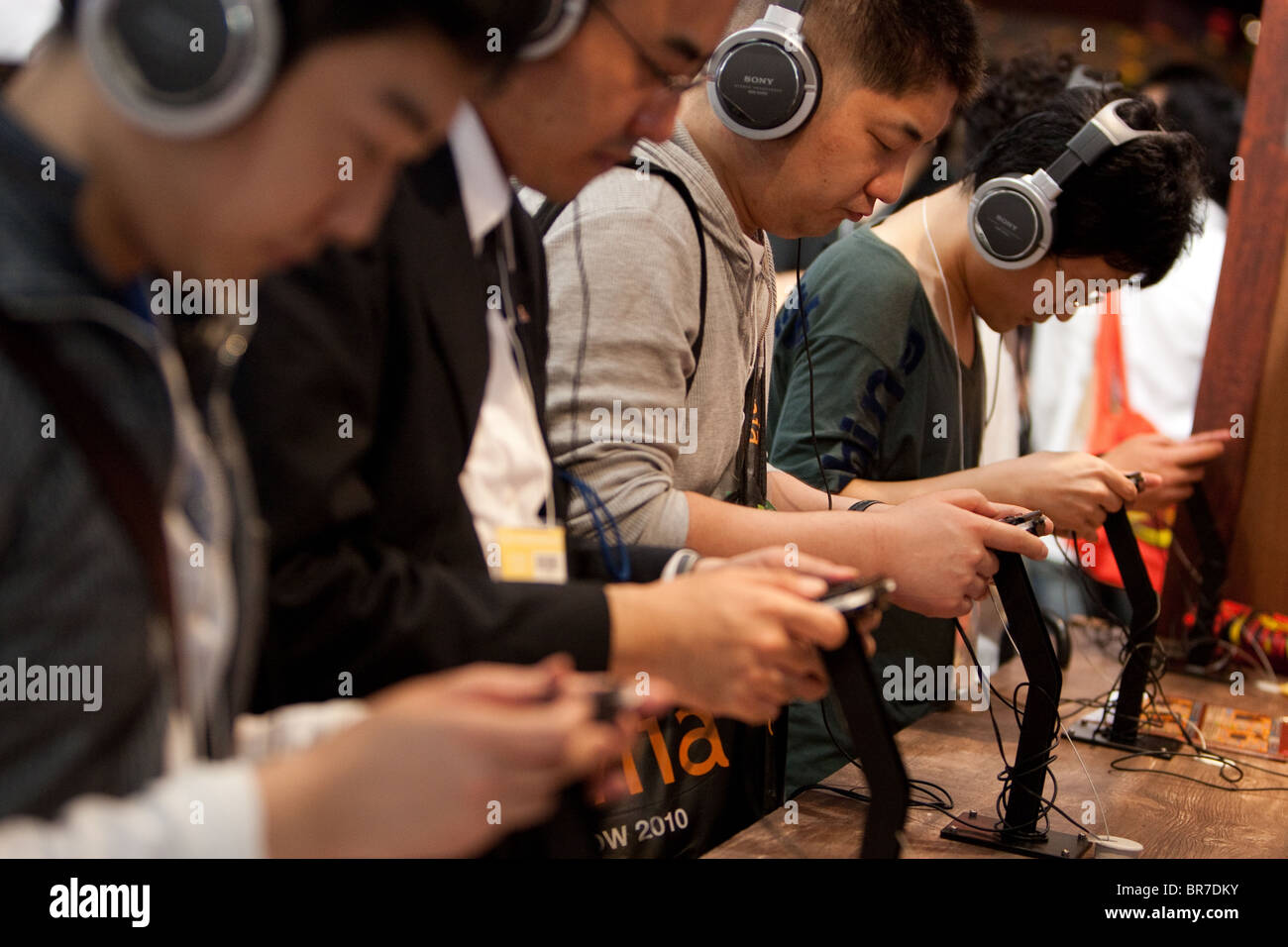 Computer gamers try new games at the trade stalls of various game