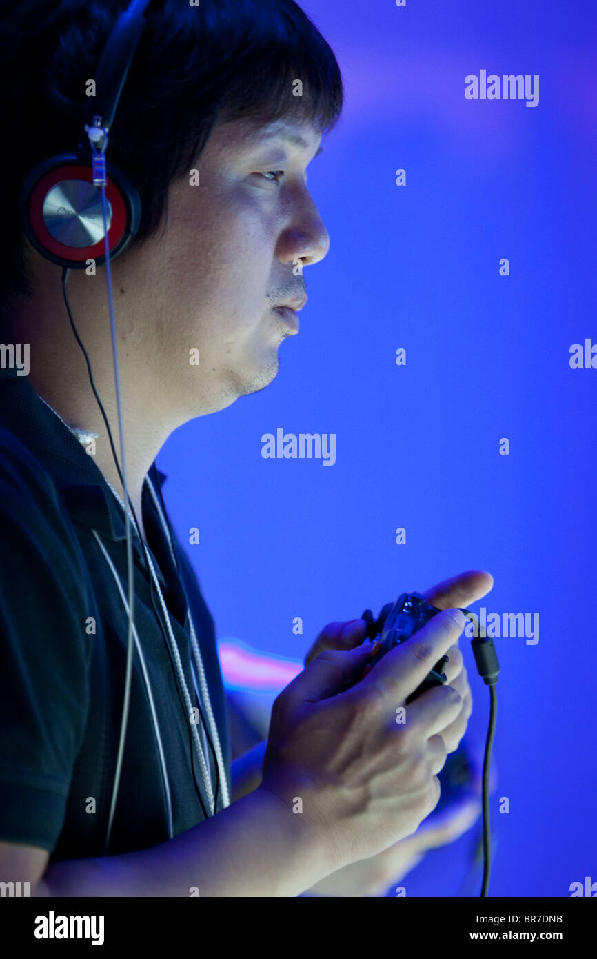 Computer gamers try new games at the trade stalls of various game manufacturing companies at the 2010 Tokyo Games Show. Stock Photo