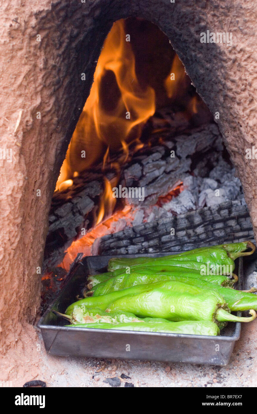 Roasting green chile in a traditional oven in New Mexico Stock Photo