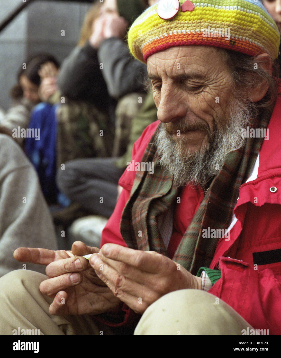 Senior man rolls a joint Stock Photo