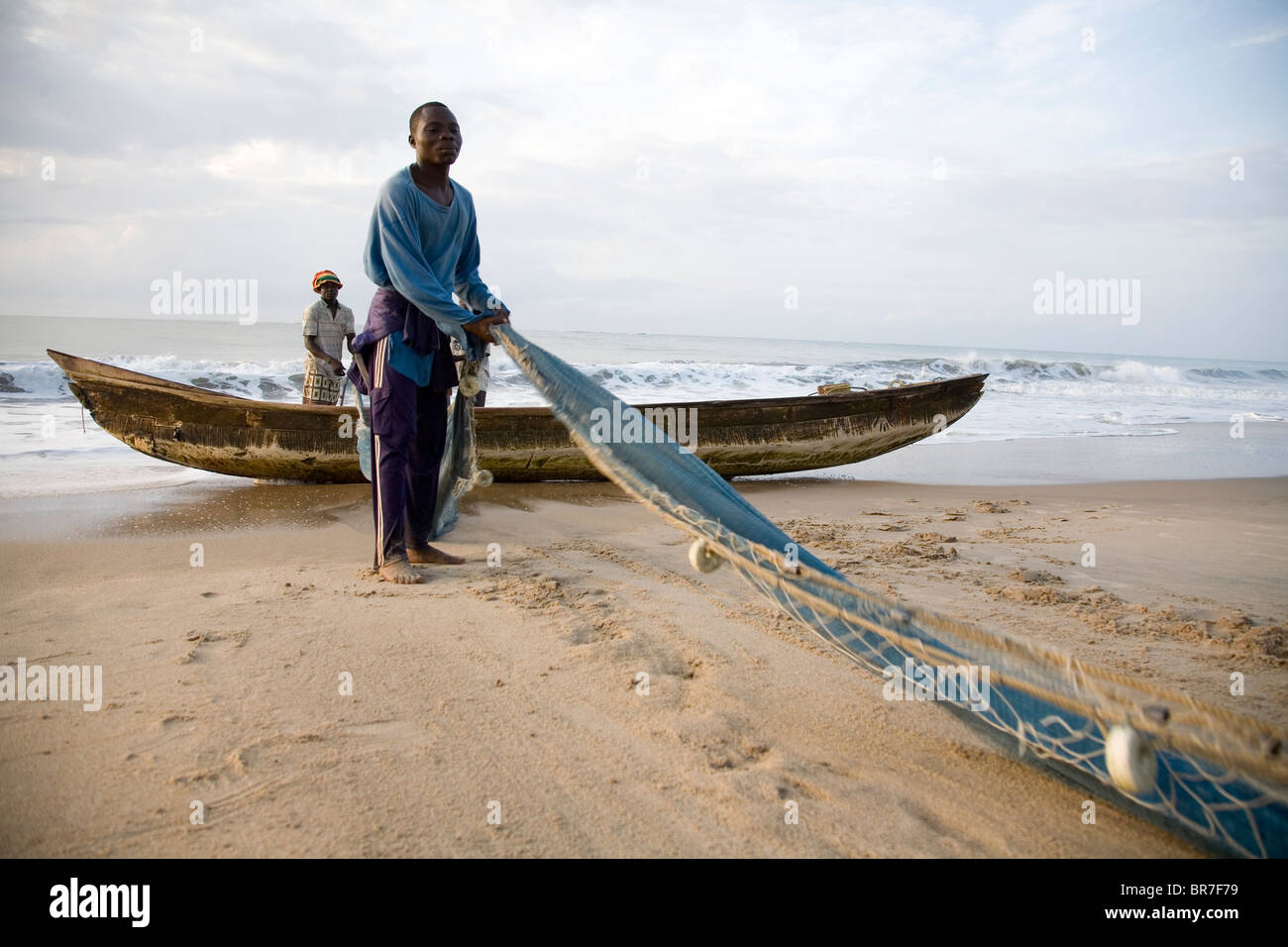 Ghanaian Fishermen pulling nets on a beach in Ghana Stock Photo