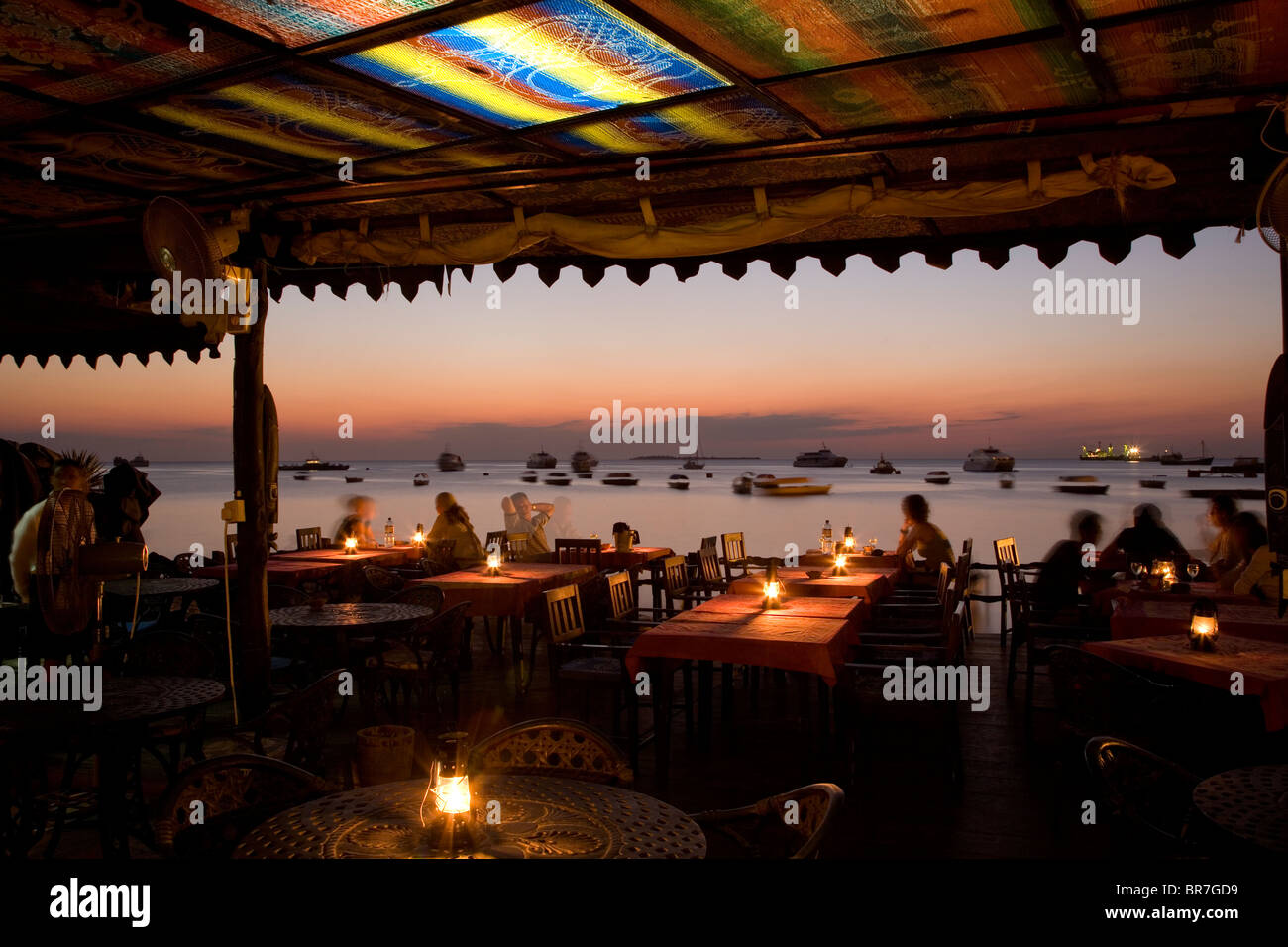 An outdoor restaurant at dusk in Zanzibar. Stock Photo
