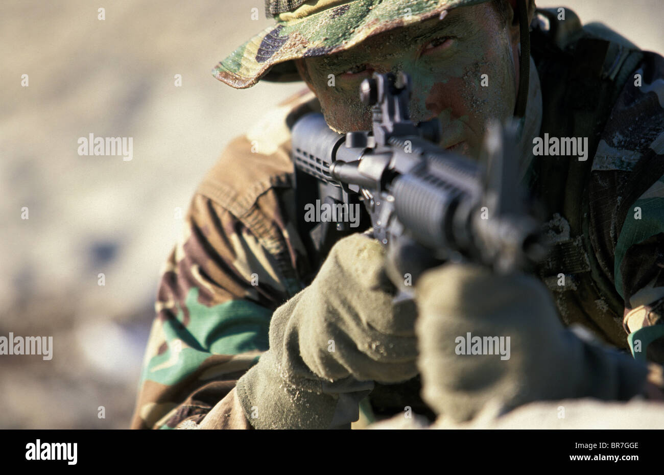 Navy Seal in training laying on the beach aiming a gun in San Diego California Stock Photo Alamy