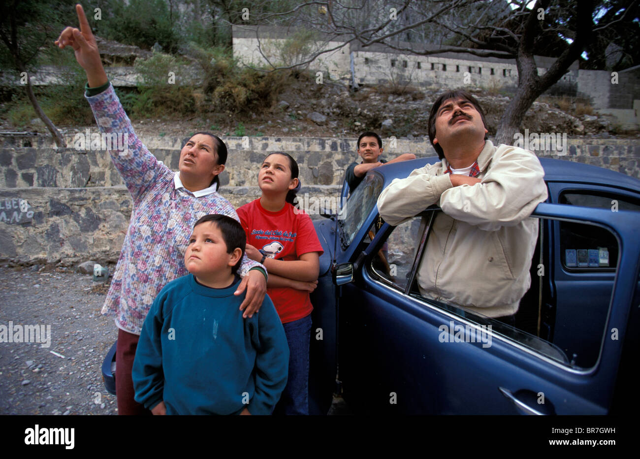 Local villagers look up and point as they watch climbers at El Potrero Chico Mexico. Stock Photo