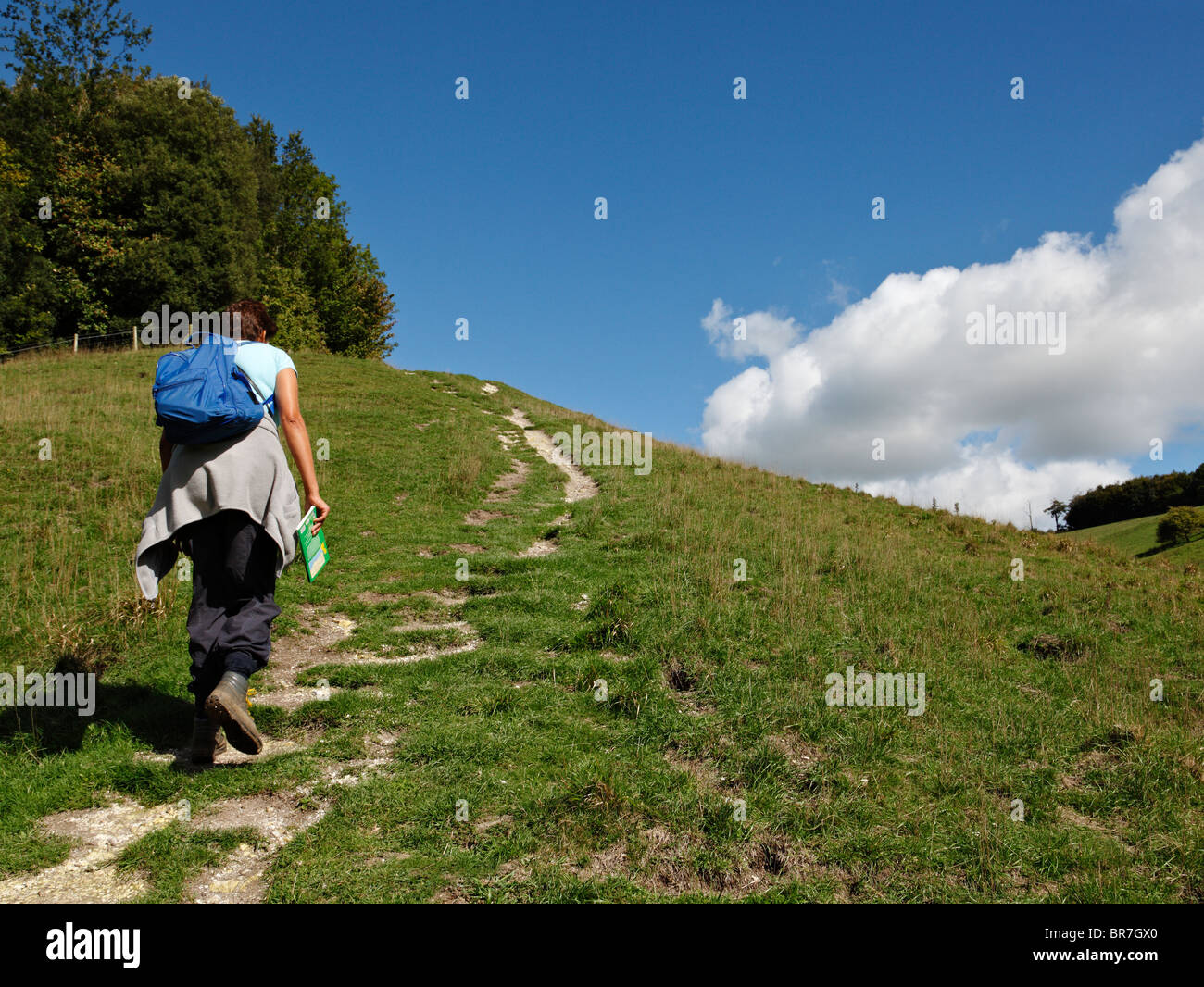 Woman walking along the South Downs. Stock Photo