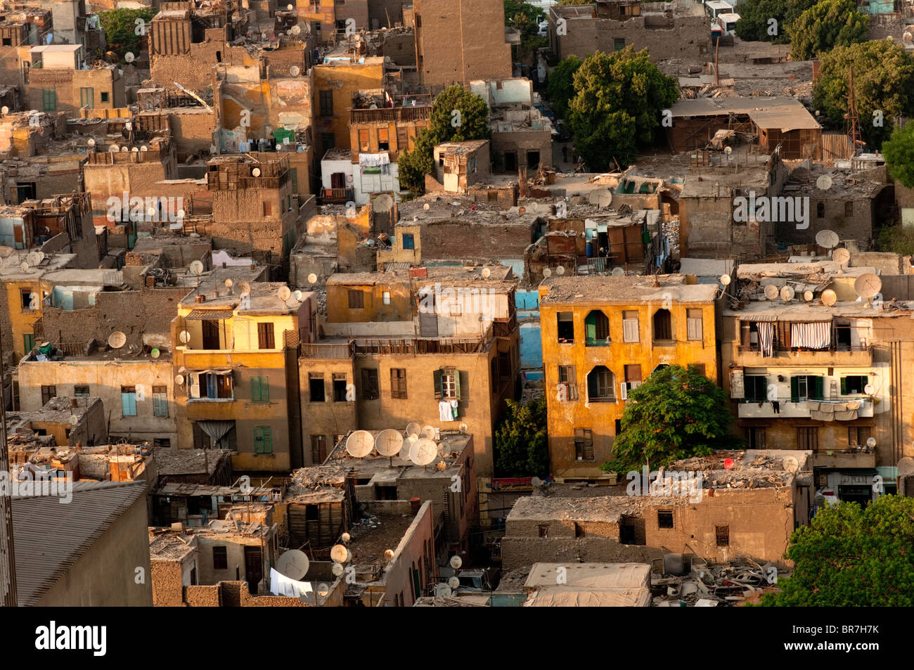 Close up evening shot of the roofs of slum housing in Cairo bristling with satellite dishes despite the poverty. Stock Photo