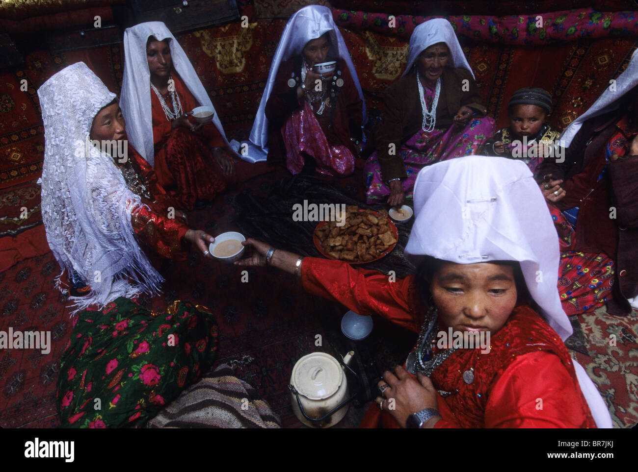 Kirghiz women in traditional dress in a yurt during wedding Little Pamir Wakhan Afghanistan. Stock Photo