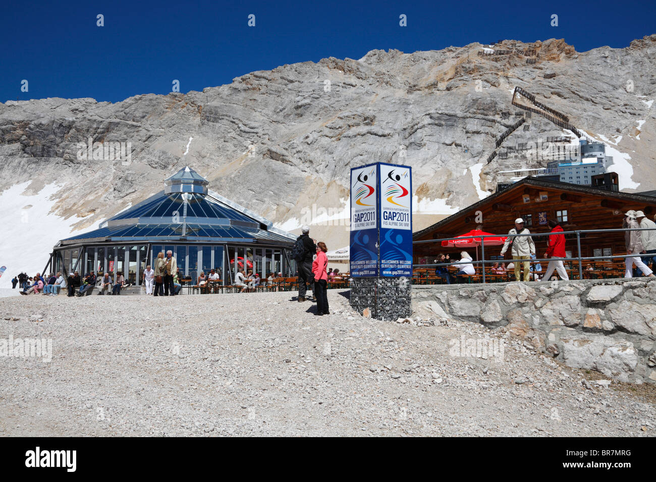 The Zugspitze Zugspitzplatt plateau in summer with restaurants,  cogwheel and cable car station and view towards the summit Stock Photo