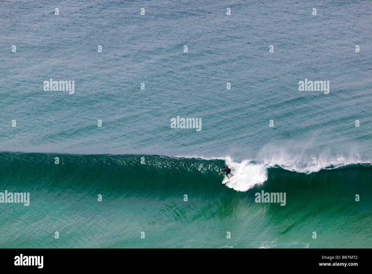 Surfer at Chapel Porth; Cornwall Stock Photo
