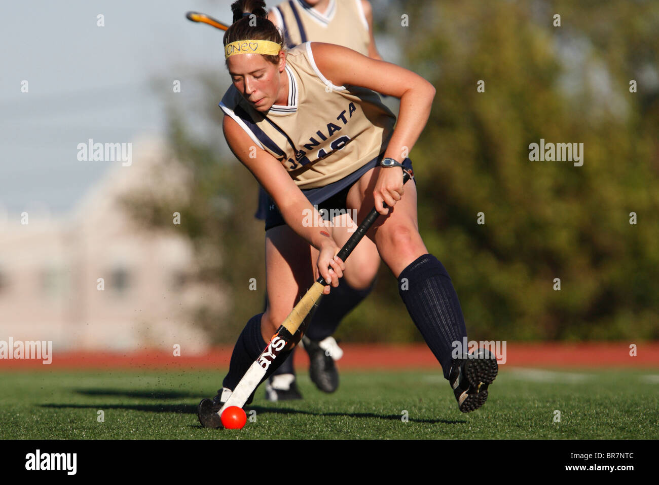 A Juniata College player controls the ball against Catholic University during the Landmark Conference field hockey championship Stock Photo