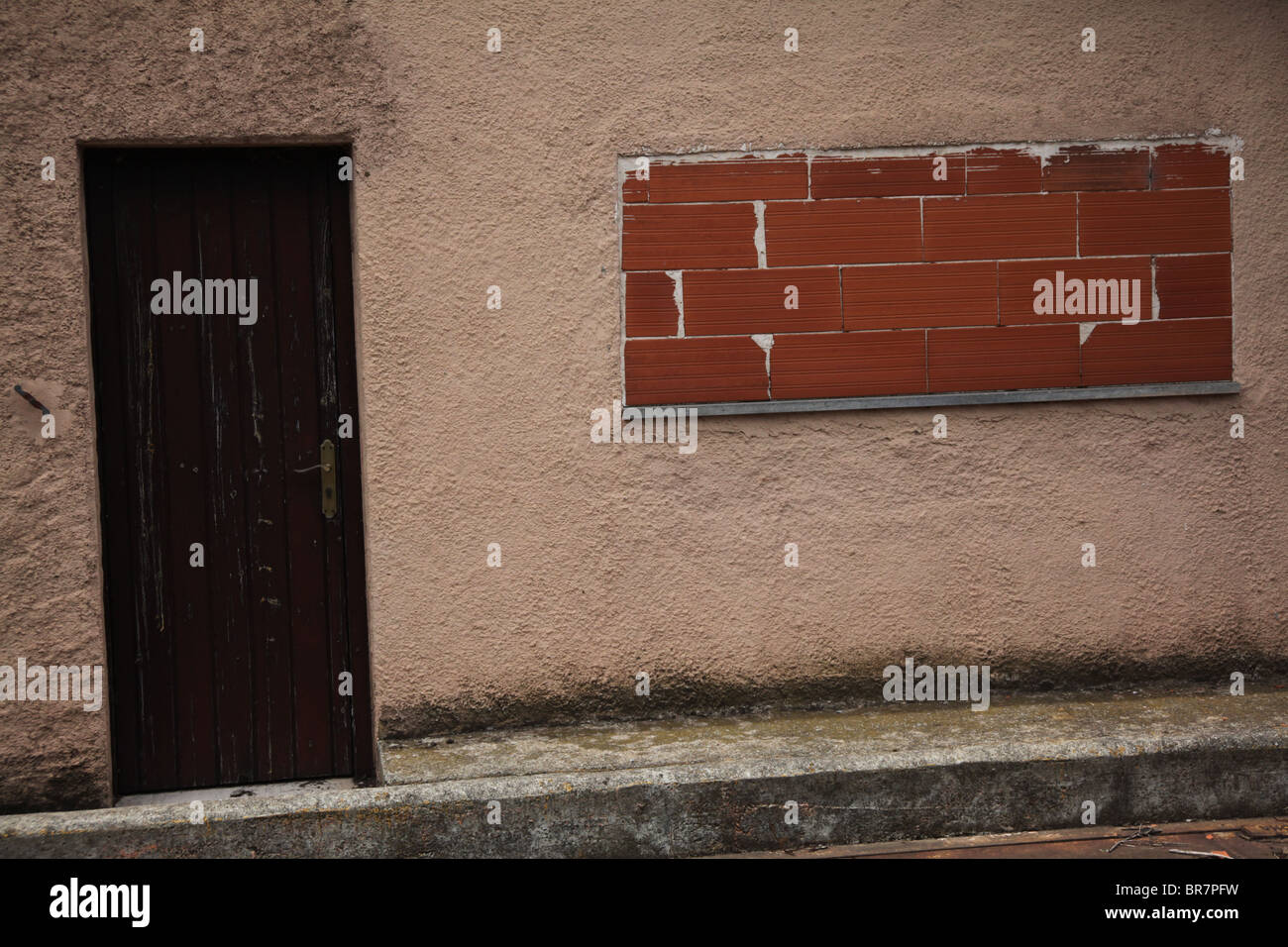 A vacant house with a bricked up window near Olot in Catalonia Spain Stock Photo