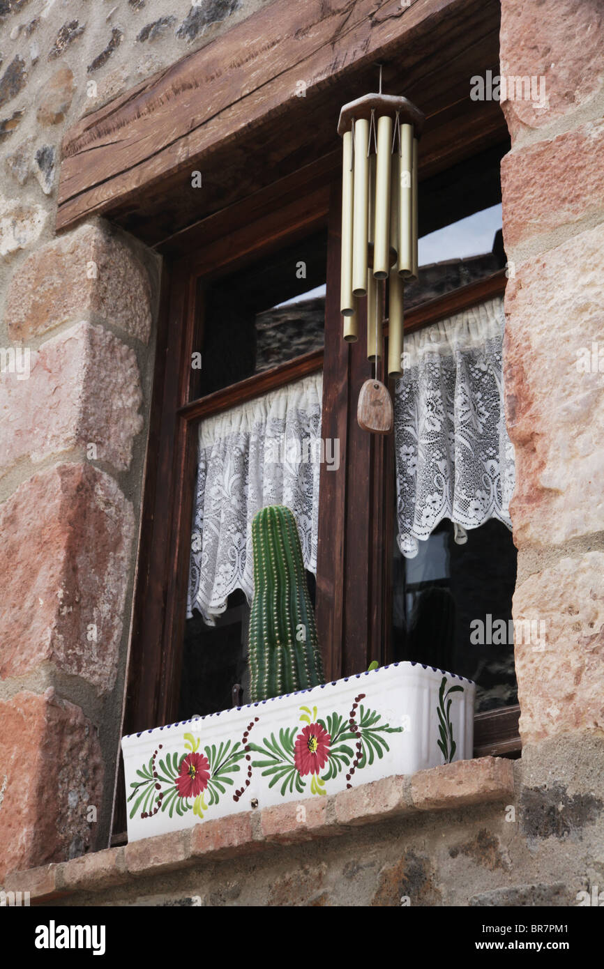 Cactus wind chime window box sill Santa Pau near Olot Spain Stock Photo