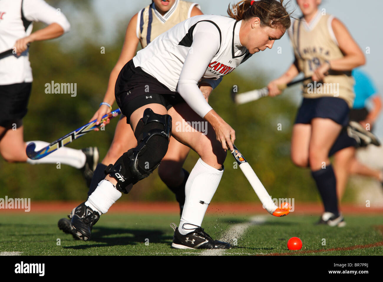 A Catholic University player controls the ball against Juniata College during the Landmark Conference field hockey championship. Stock Photo