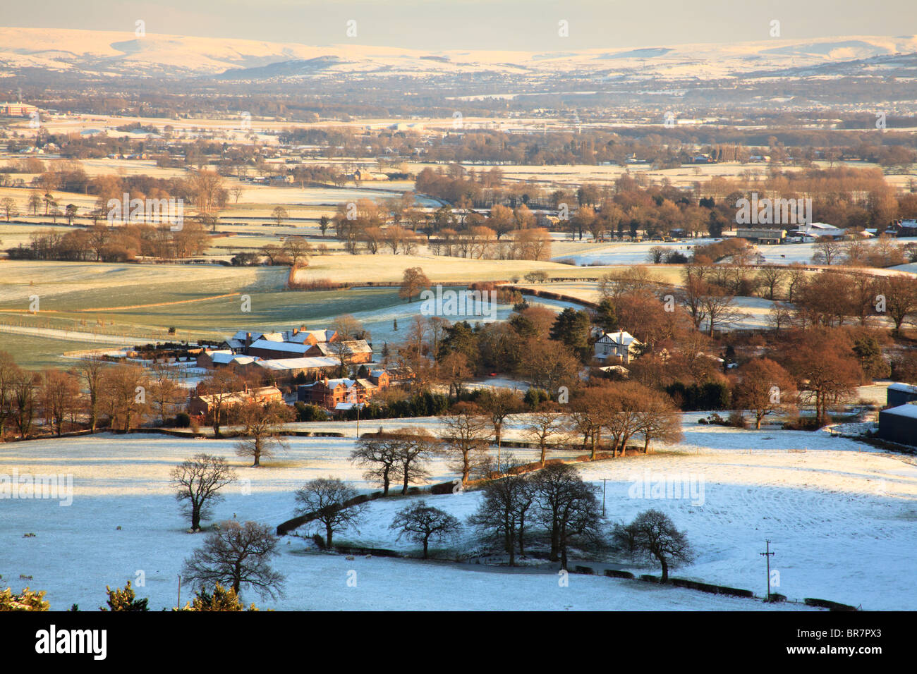 Winter scene showing snow covering a wooded farmland in Cheshire UK Stock Photo