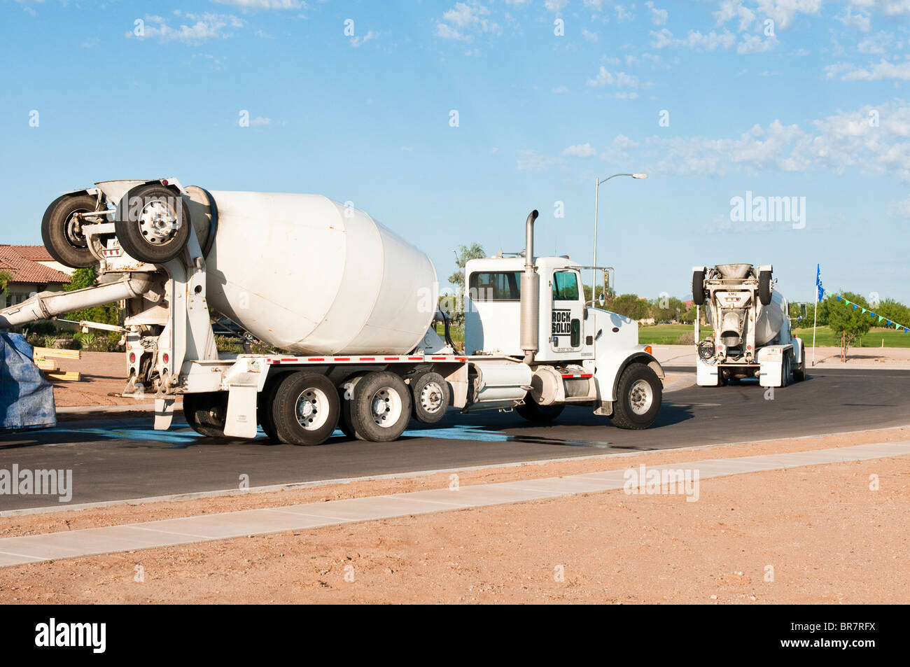 Concrete trucks deliver ready mix concrete to a residential