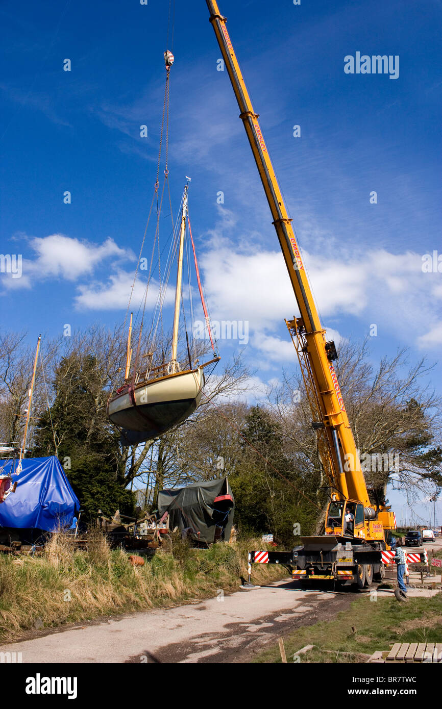 Crane lifting a yacht Stock Photo Alamy