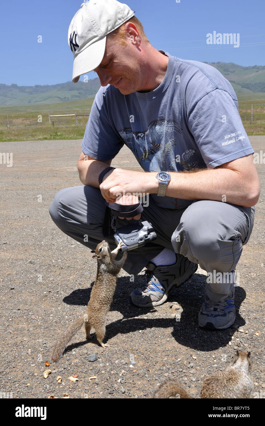 Man feeding squirrels in Big Sur, California, USA Stock Photo Alamy