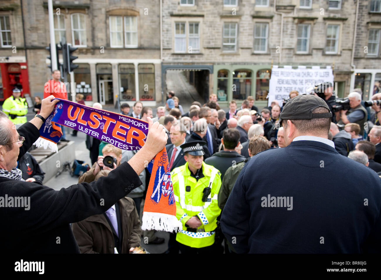 Man holding scarf with Protestant slogan as Ian Paisley addresses crowd in Edinburgh's Grassmarket on the day of the Papal visit Stock Photo