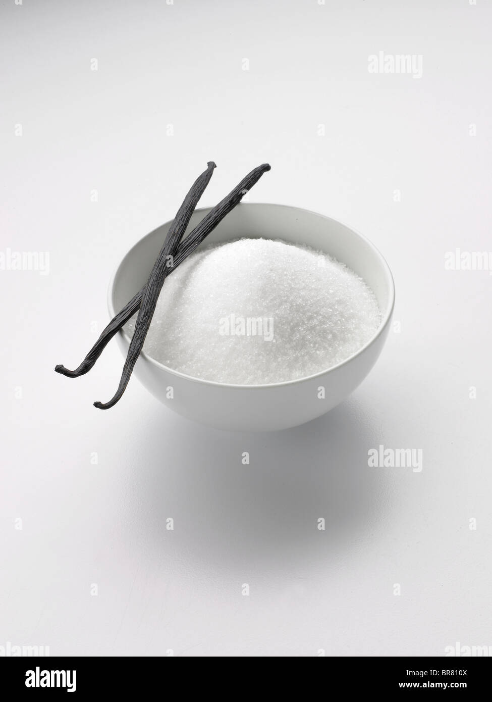 White sugar bowl with two vanilla pods Stock Photo